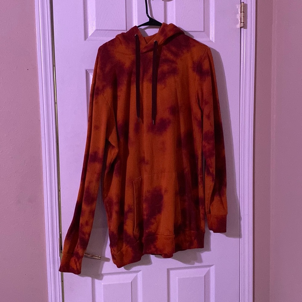 A men’s tie dyed orange hoodie.